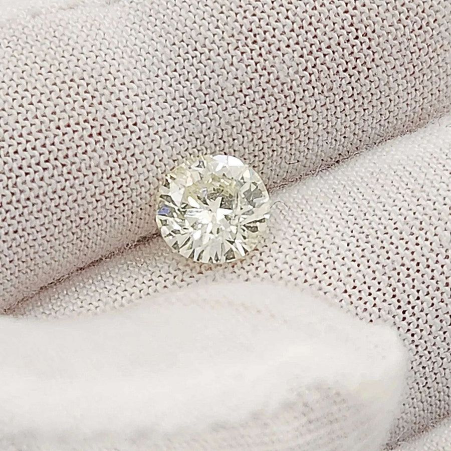 1.40 Carat I2, Color M, Round Brilliant Cut Natural Diamond.