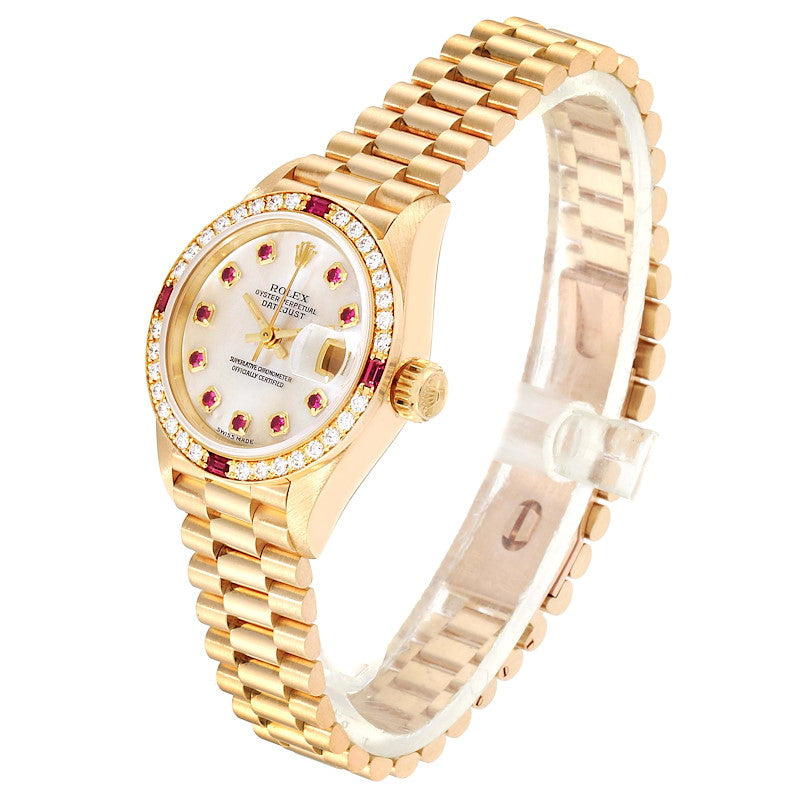 Ladies Rolex Presidential 26mm Solid 18K Yellow Gold Watch with Mother of Pearl Ruby Dial and Diamond Bezel. (Pre-Owned 7906B)