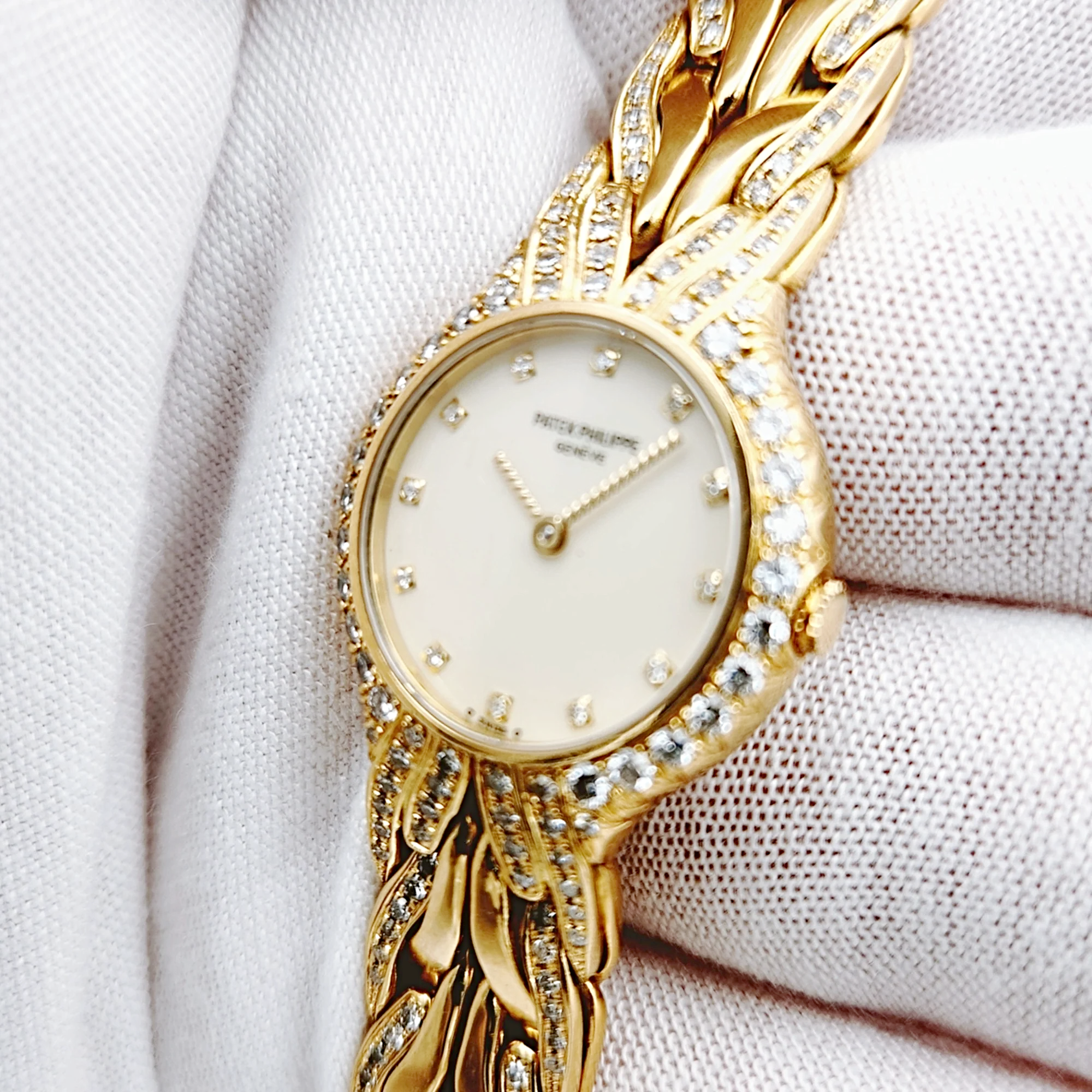 Ladies Patek Philippe 23mm La Flamme 18K Yellow Gold Watch with Cream Diamond Dial and Diamond Bezel. (Pre-Owned Model 4816/3)