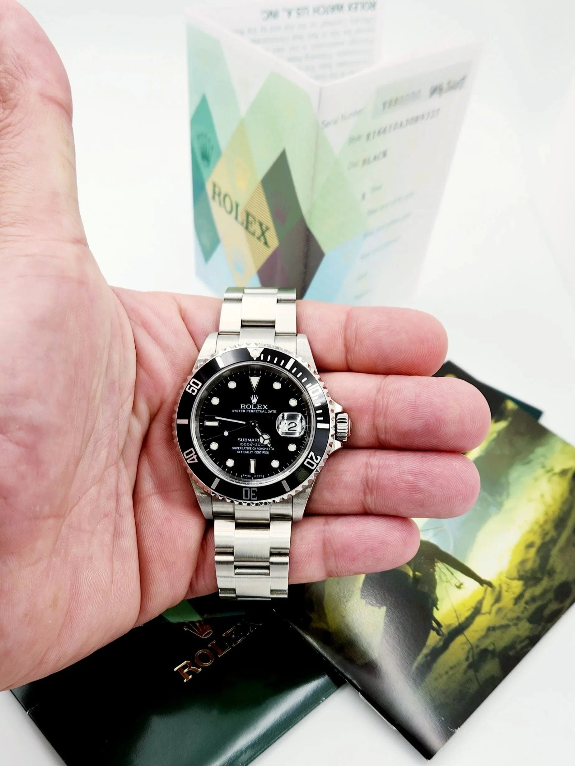 Men's Rolex 40mm Submariner Oyster Perpetual Date Stainless Steel Watch with Black Dial and Black Bezel. (Pre-Owned 16610)