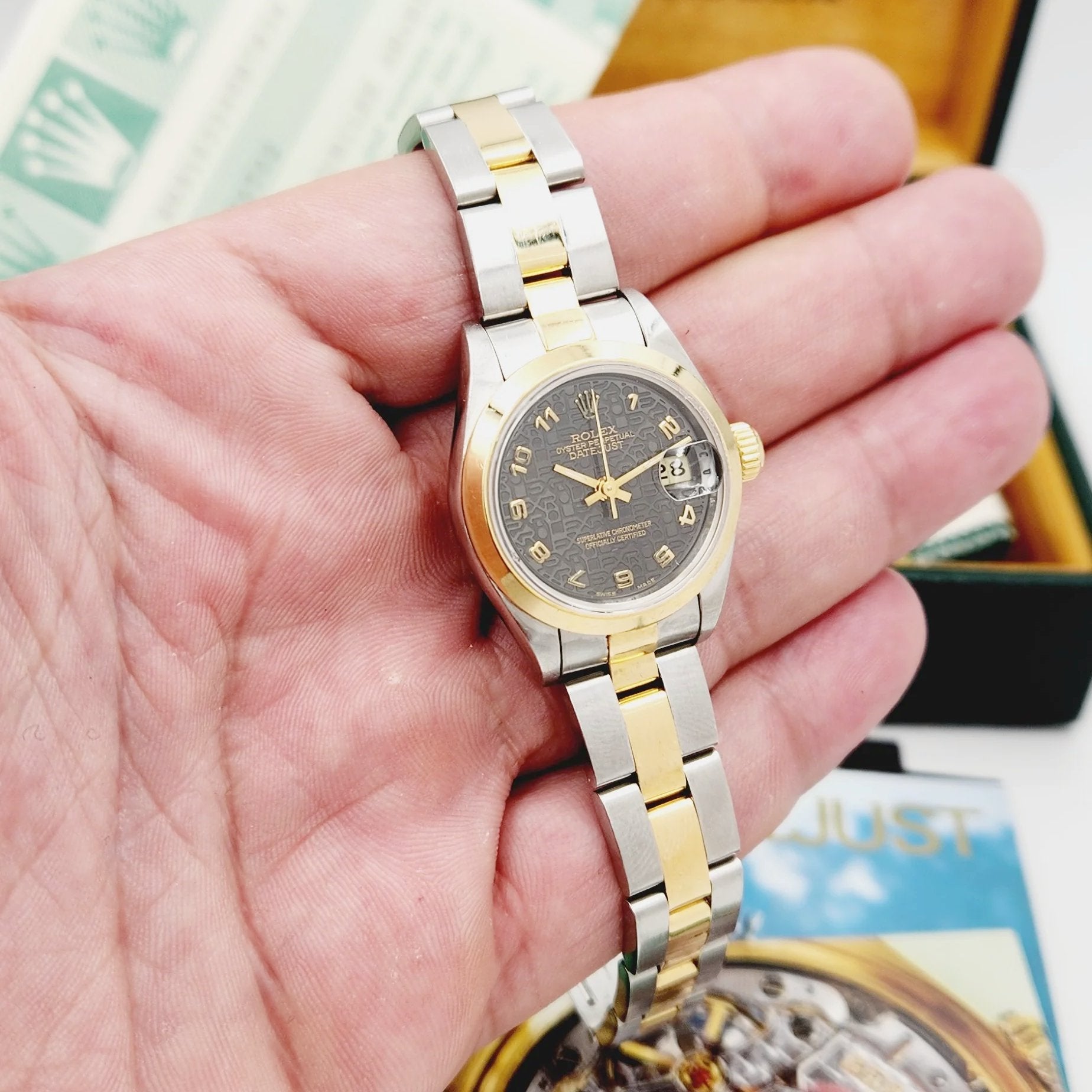 Ladies Rolex 26mm DateJust Two Tone 18K Yellow Gold / Stainless Steel Watch with Dark Brown Slate Dial and Smooth Bezel. (Pre-Owned 69163)