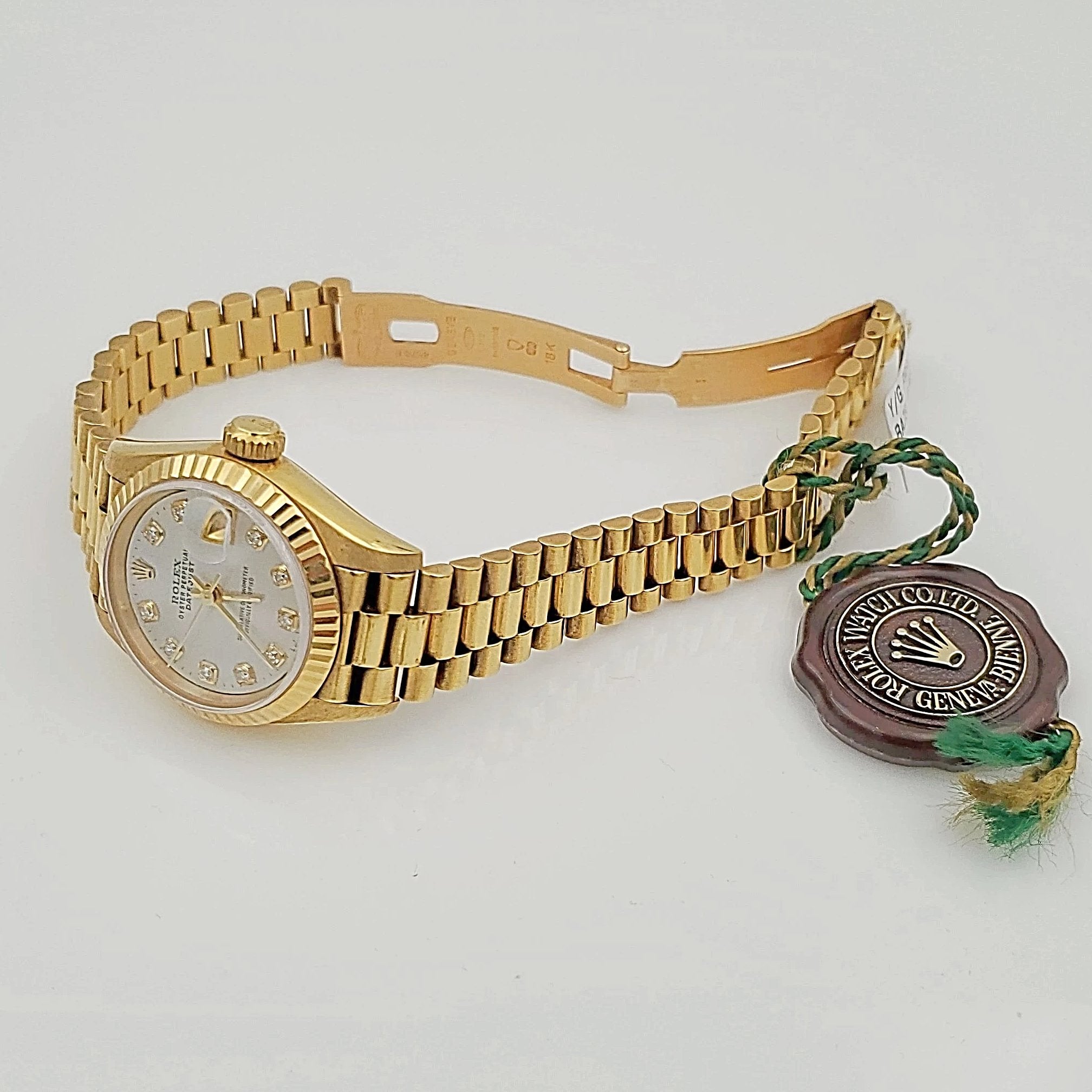Ladies Rolex 26mm Presidential 18K Solid Yellow Gold Watch with Mother of Pearl Diamond Dial and Fluted Bezel. (Pre-Owned)