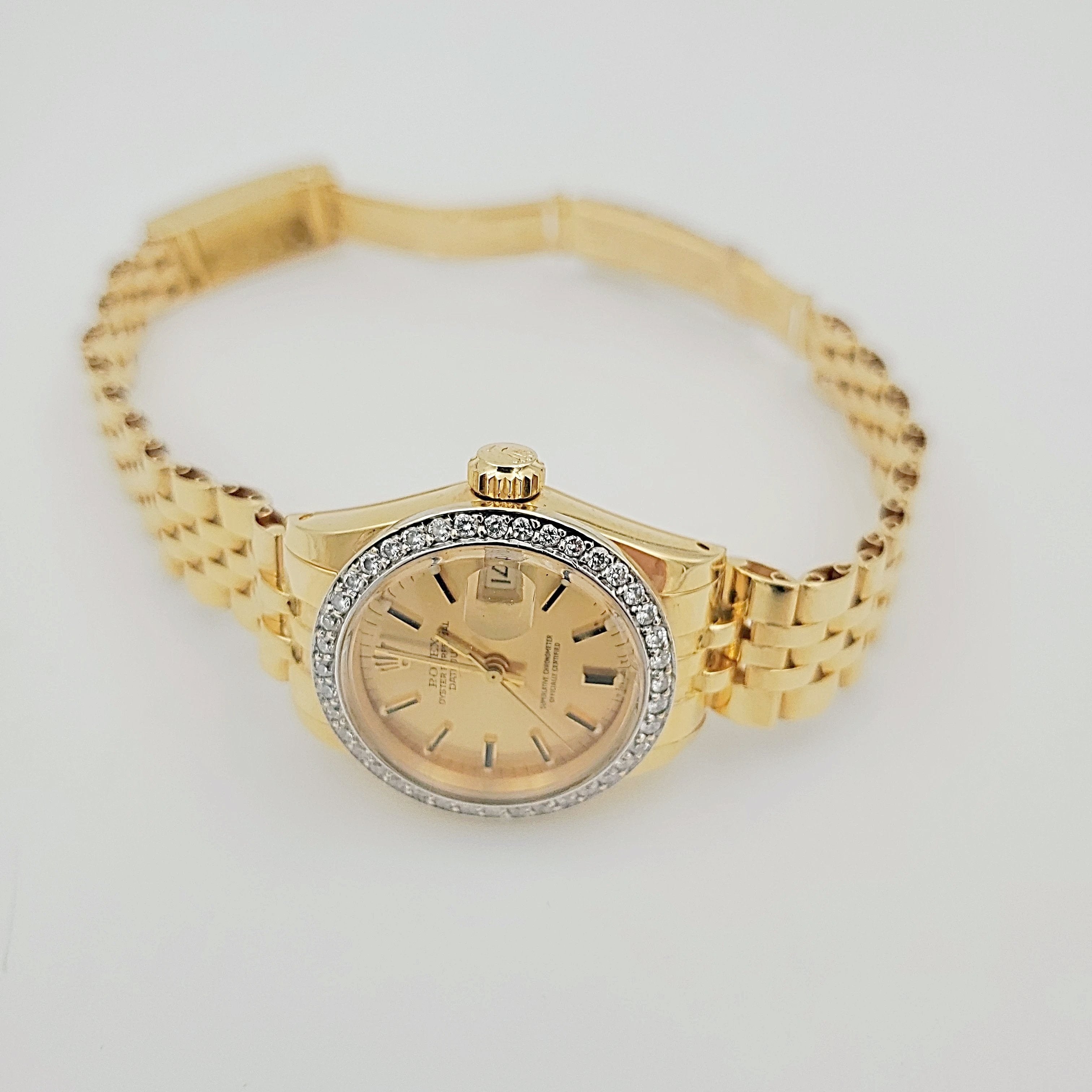 Ladies Rolex 26mm DateJust 18K Yellow Gold Watch with Champagne Dial and Custom Diamond Bezel. (Pre-Owned)