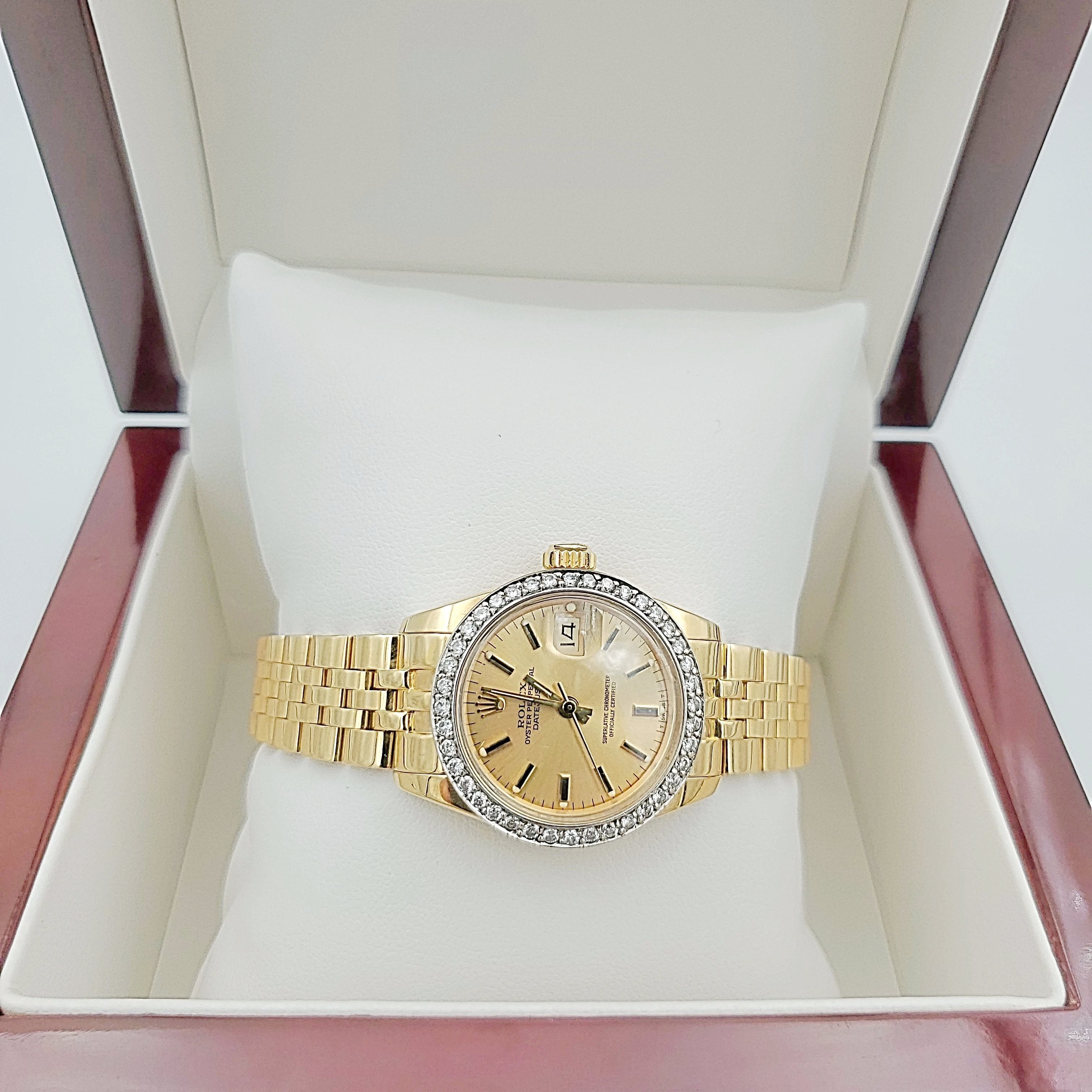 Ladies Rolex 26mm DateJust 18K Yellow Gold Watch with Champagne Dial and Custom Diamond Bezel. (Pre-Owned)