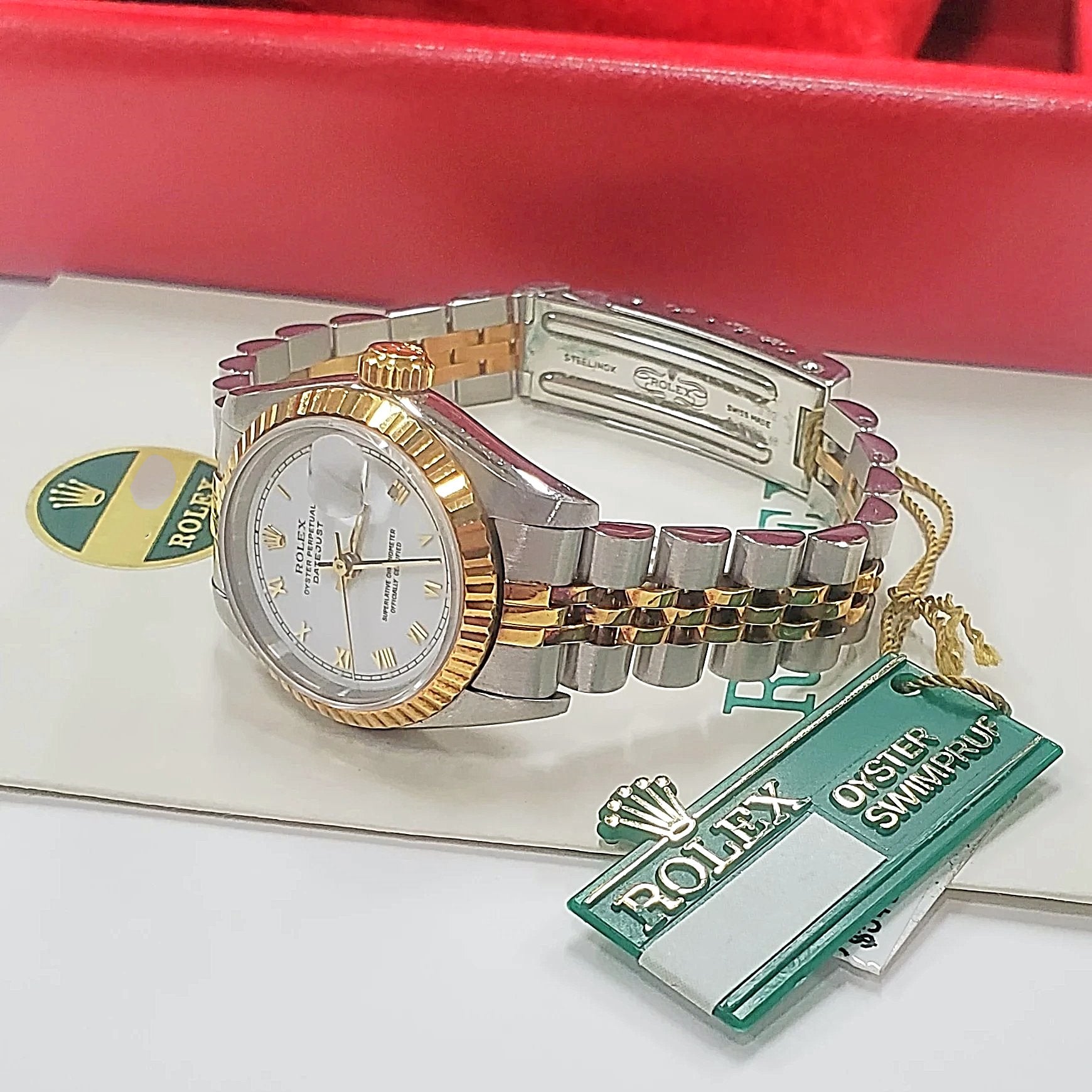 Women's Rolex 26mm DateJust Two-Tone 18K Gold Watch, with White Dial, Fluted Bezel, and Roman Numerals.
