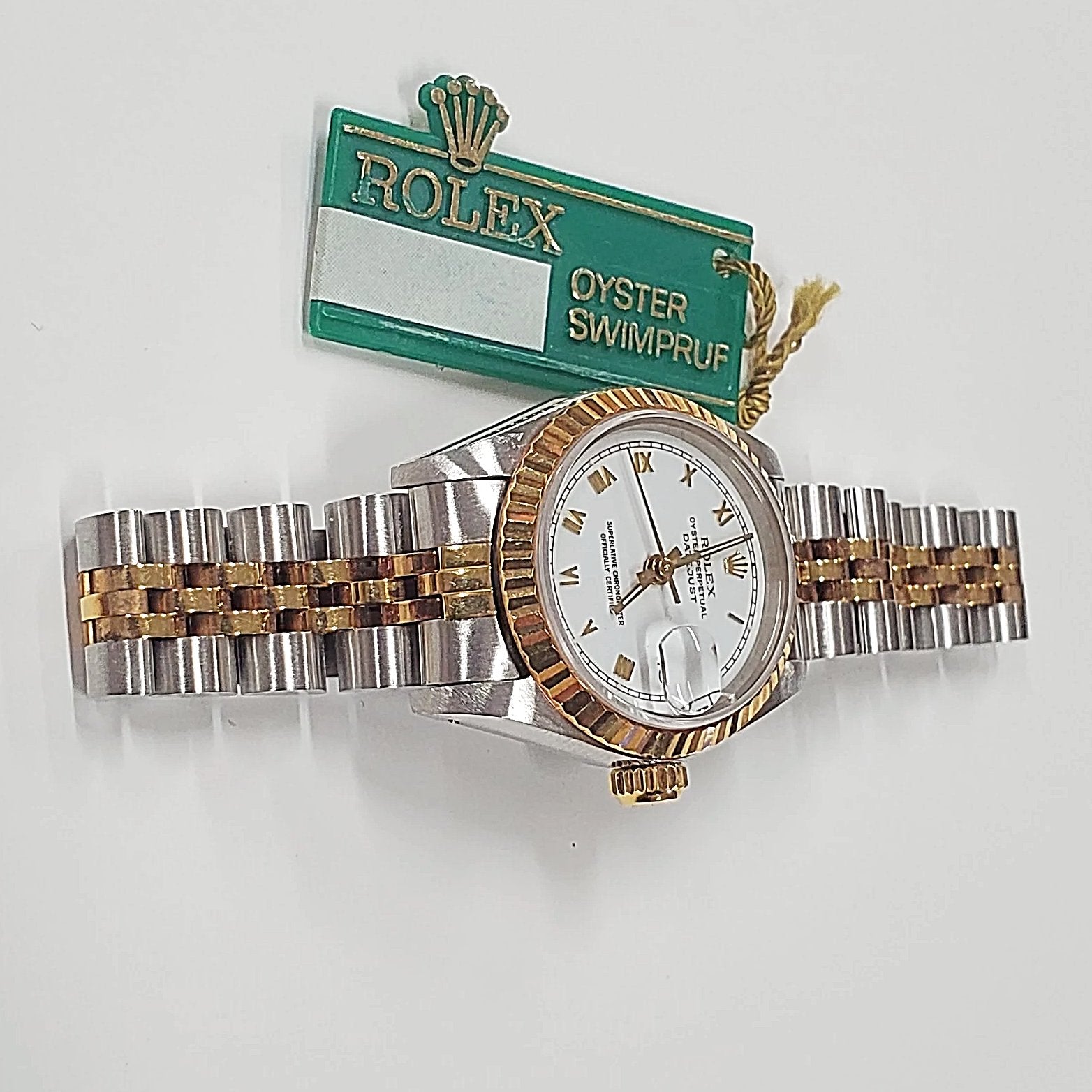 Ladies Rolex 26mm DateJust Two Tone 18K Gold Watch with White Dial, Fluted Bezel and Roman Numerals. (Pre-Owned)