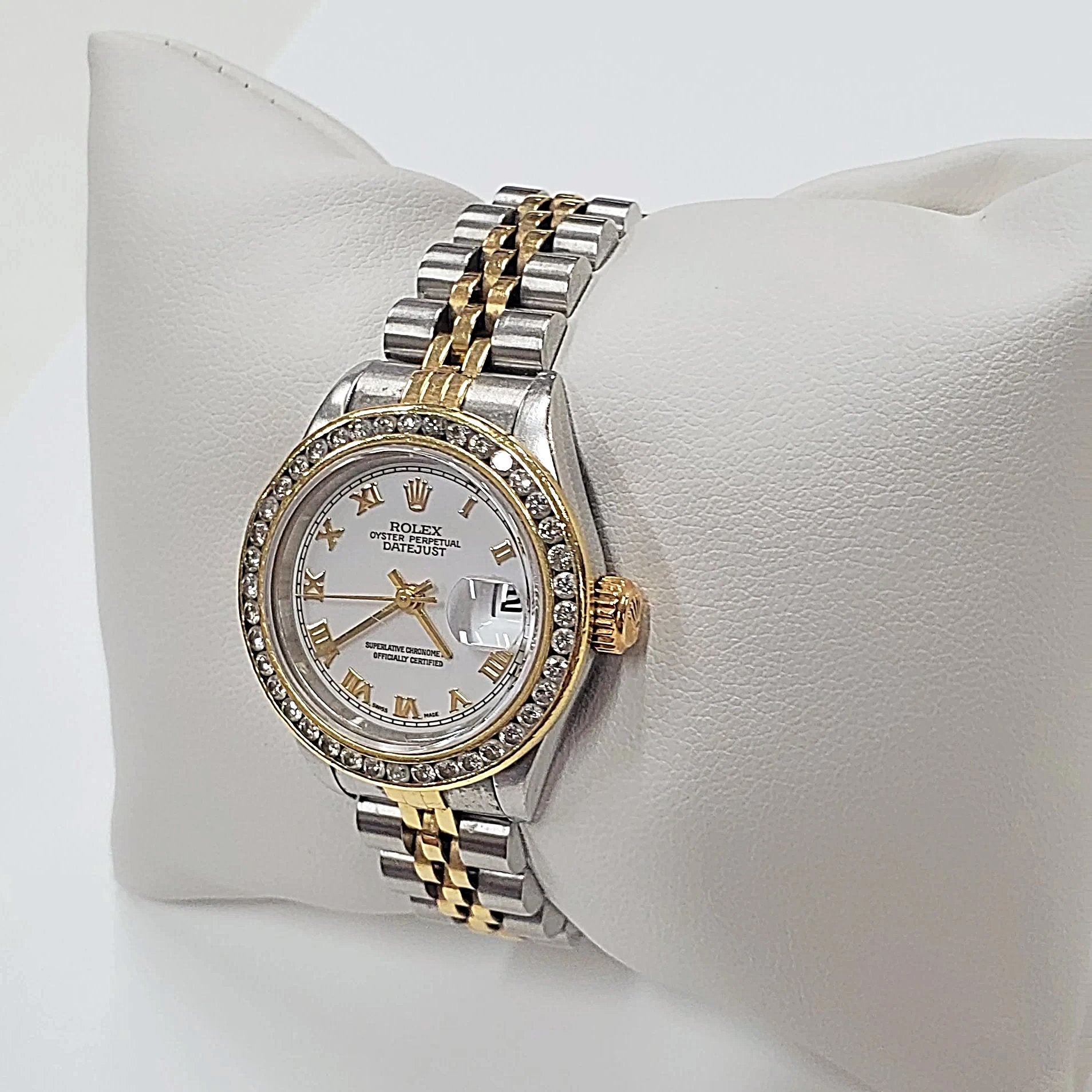 Women's Rolex 18K Gold Two-Tone 26mm DateJust Watch, with Diamond Bezel, White Dial, and Roman Numerals.