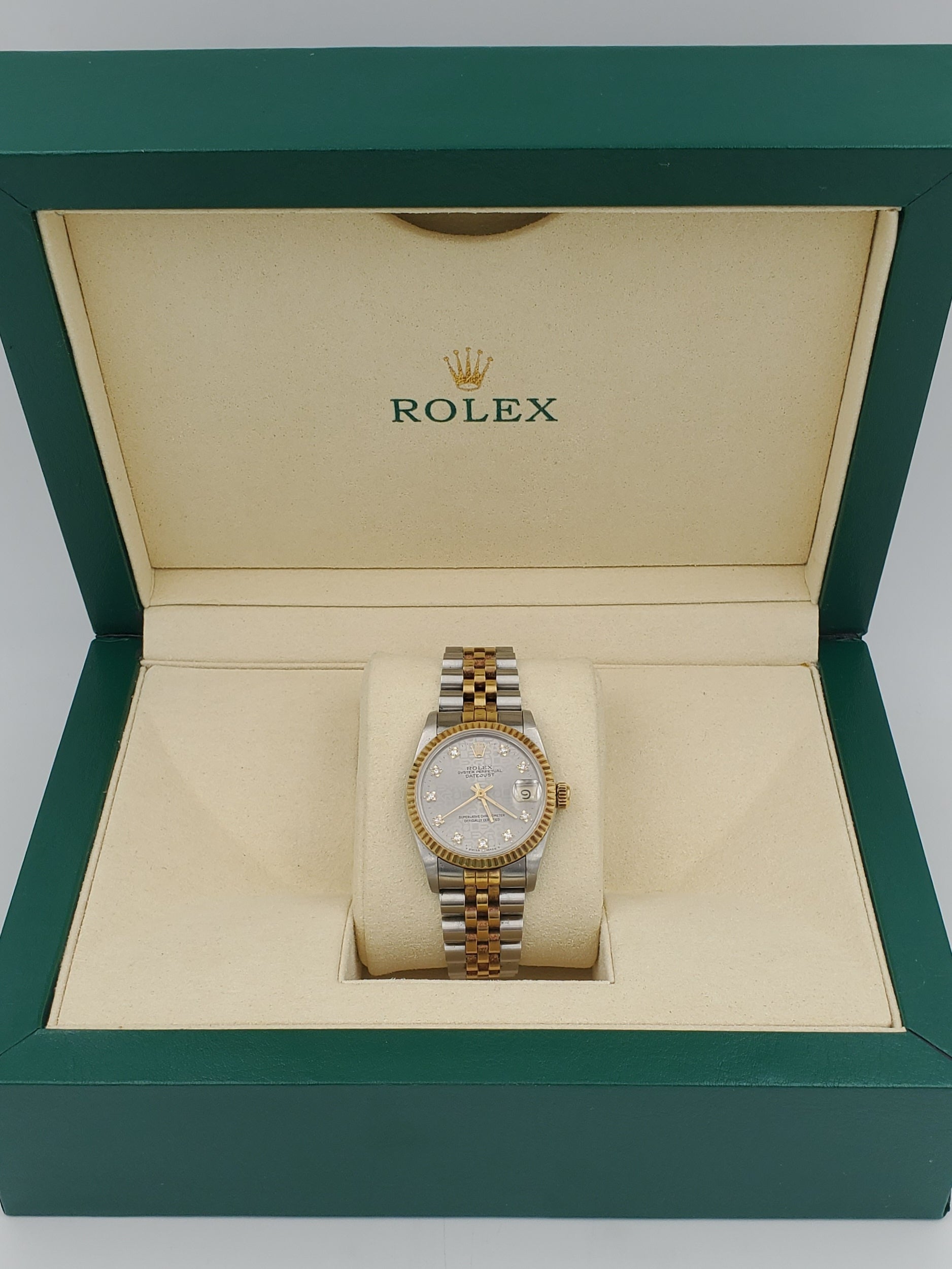 Ladies Rolex Midsize 31mm DateJust Two Tone 18K Yellow Gold / Stainless Steel Watch with Silver Diamond Dial and Fluted Bezel. (Pre-Owned 682735)