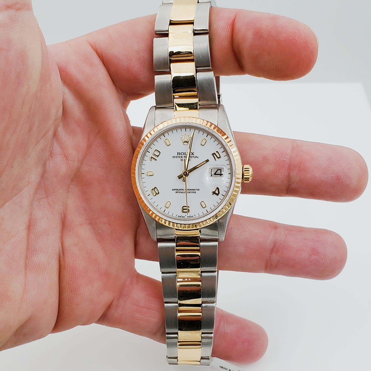 Unisex Rolex DateJust 34mm Two Tone 18k Gold / Stainless Steel Oyster Band Watch with White Dial, Gold Numeral and Fluted Bezel. (Pre-Owned)