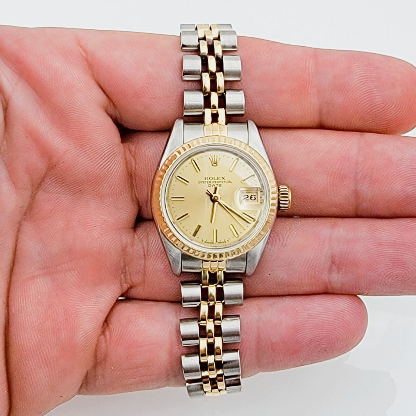 Ladies Rolex 26mm Date Two Tone 18K Yellow Gold / Stainless Steel Watch with Champagne Dial and Fluted Bezel. (Pre-Owned)