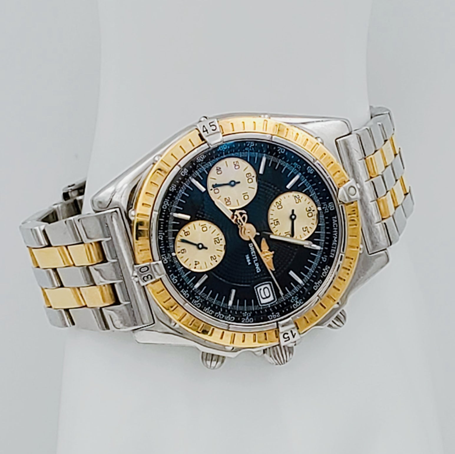 Men's Breitling Chronograph 40mm 18K Yellow Gold / Stainless Steel Watch with Black Dial and Gold Bezel. (Pre-Owned B13356)