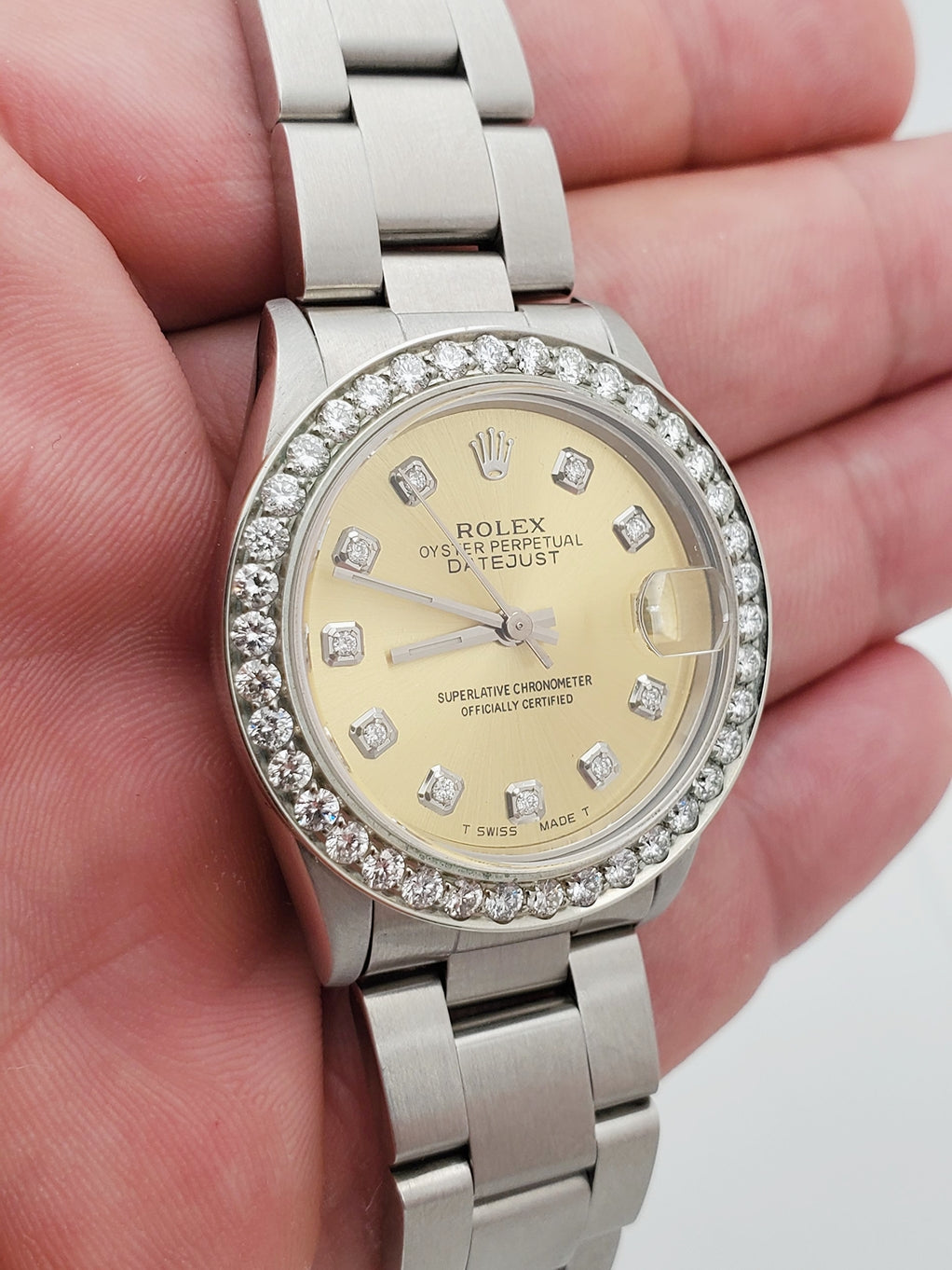 Ladies Midsize Rolex DateJust 31mm Stainless Steel Watch with Champagne Diamond Dial and Diamond Bezel. (Pre-Owned)