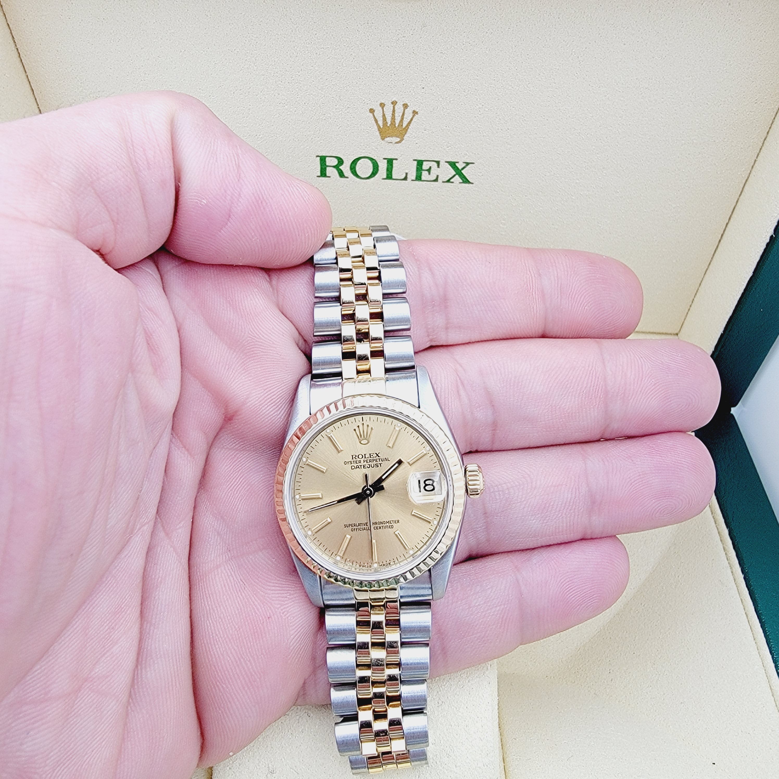 Ladies Rolex Midsize 31mm DateJust Two Tone 18K Yellow Gold / Stainless Steel Watch with Gold Dial and Fluted Bezel. (Pre-Owned 68273)